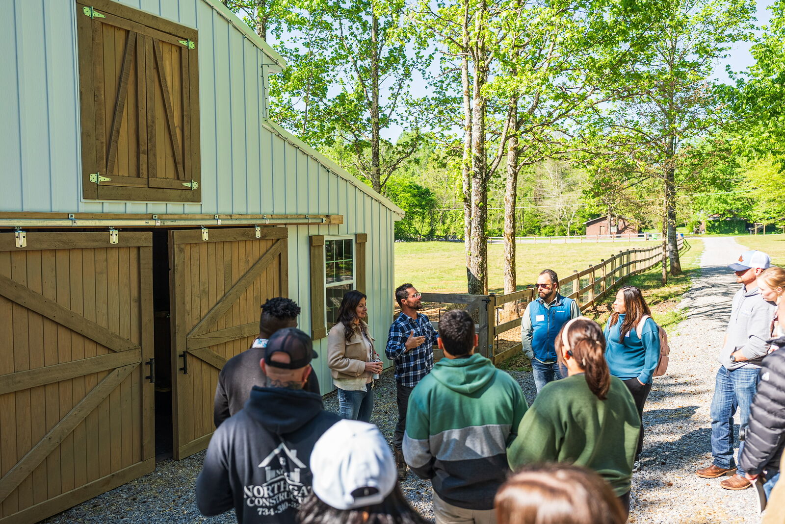 Group touring the barn at the farm